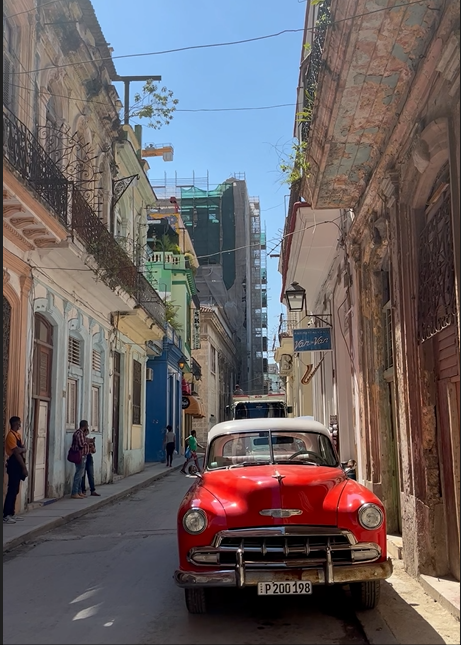 Red vintage car on narrow street